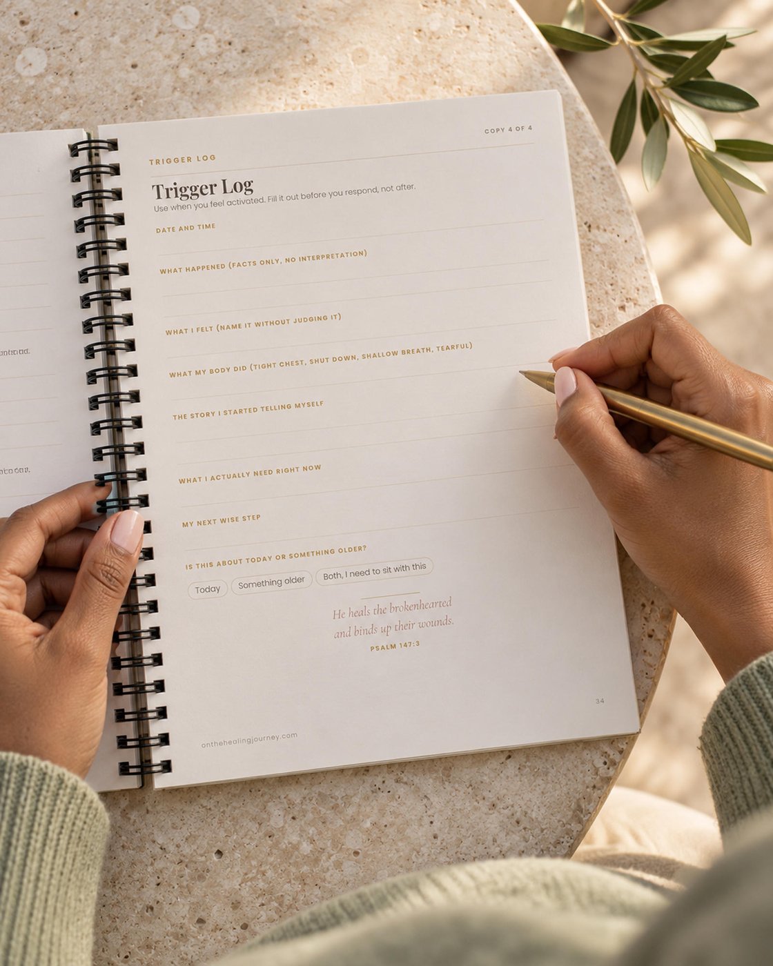 A woman filling out the Trigger Log in The Grounded Girl workbook