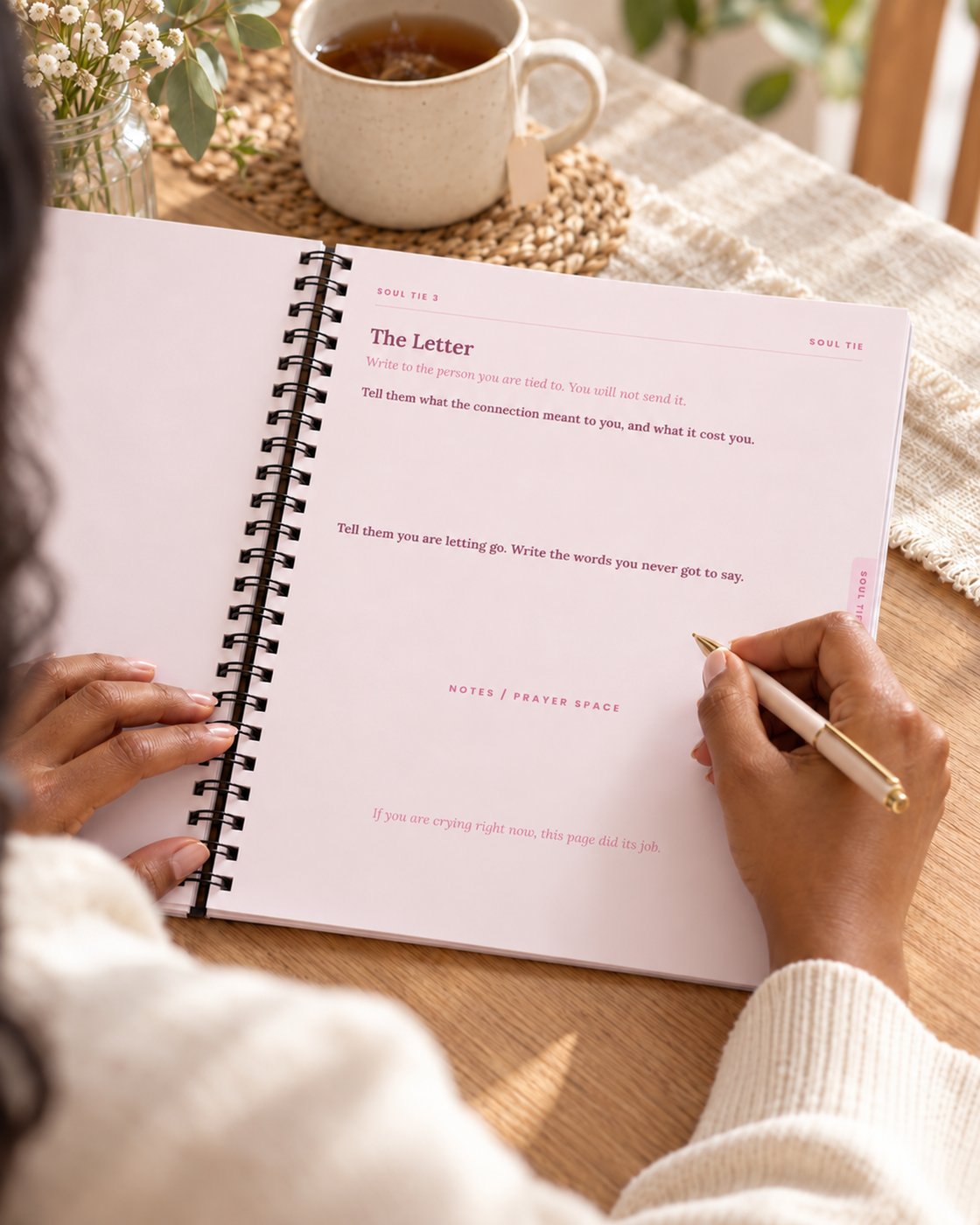 A woman writing in The Loved Girl workbook, on the Soul Tie letter page